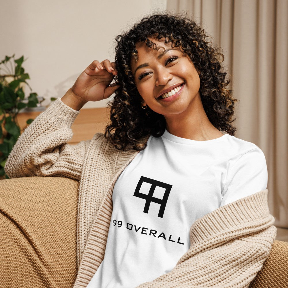 Smiling woman relaxing at home in the white 99 Overall Logo Women's Relaxed Tee