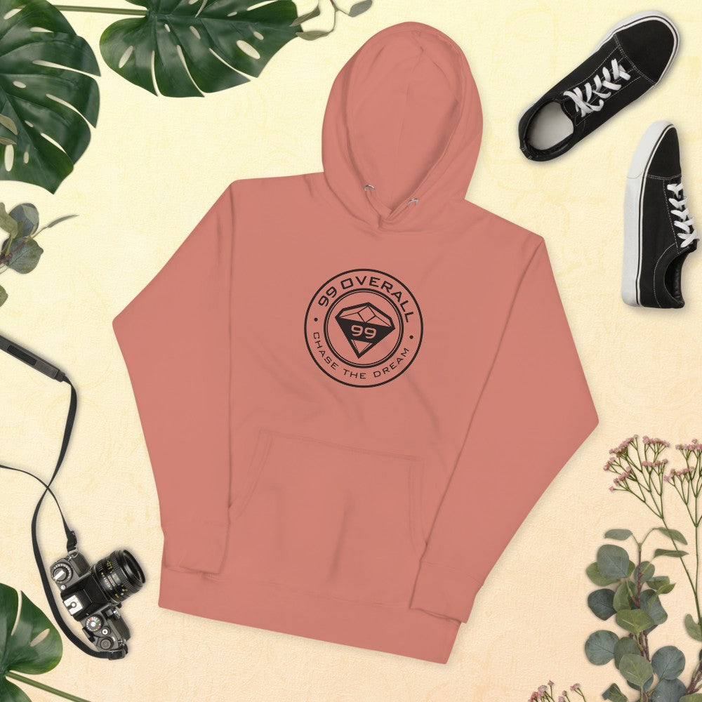 Dusty Rose Diamond 99 Badge Hoodie laid flat with sneakers and a camera