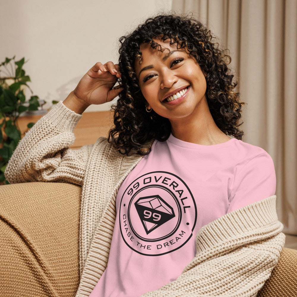Smiling woman relaxing at home in the pink Diamond 99 Badge Women's Relaxed Tee