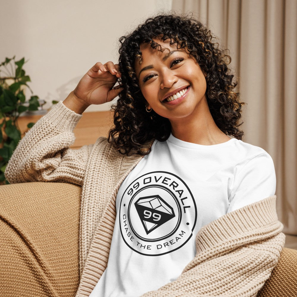 Woman relaxing at home in the white Diamond 99 Badge Women's Relaxed Tee
