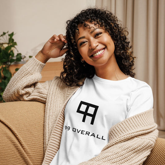Smiling woman relaxing at home in the white 99 Overall Logo Women's Relaxed Tee
